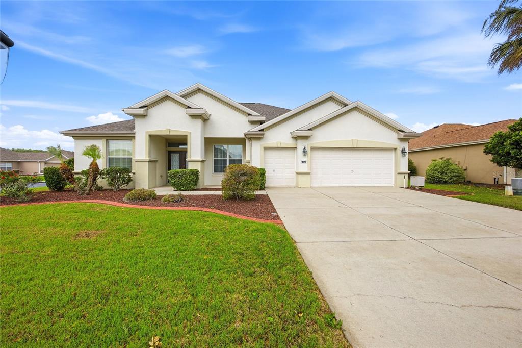 9029 Southeast 130th Loop Summerfield, FL 34491 - Photo 2 of 55 a view of house with garden and tall tress