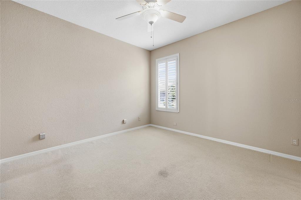 9029 Southeast 130th Loop Summerfield, FL 34491 - Photo 29 of 55 an empty room with a chandelier fan and windows