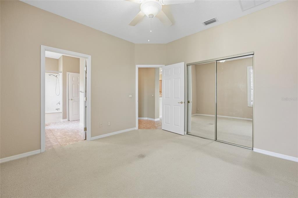 9029 Southeast 130th Loop Summerfield, FL 34491 - Photo 30 of 55 an empty room with closet and a chandelier fan