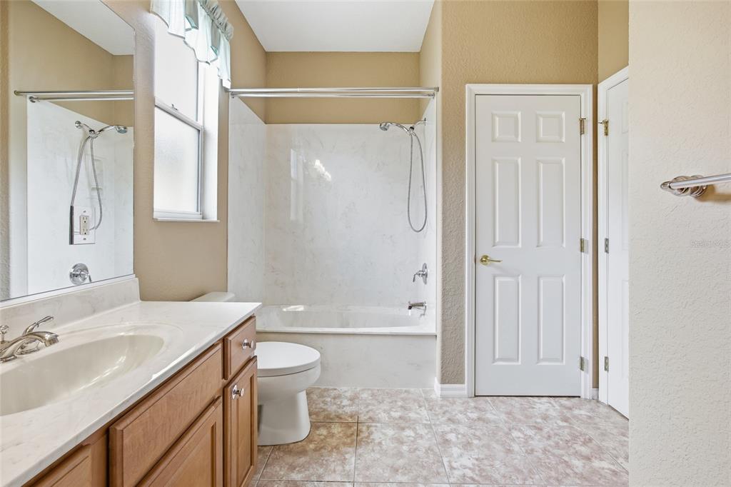 9029 Southeast 130th Loop Summerfield, FL 34491 - Photo 32 of 55 a bathroom with a sink a toilet and shower