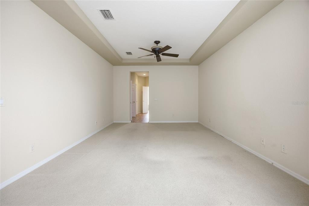 9029 Southeast 130th Loop Summerfield, FL 34491 - Photo 36 of 55 an empty room with chandelier fan and windows