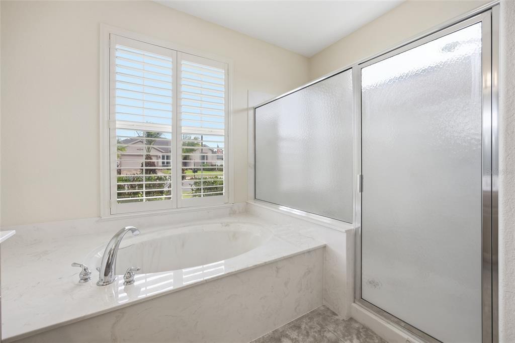 9029 Southeast 130th Loop Summerfield, FL 34491 - Photo 39 of 55 a bathroom with a bathtub and a shower