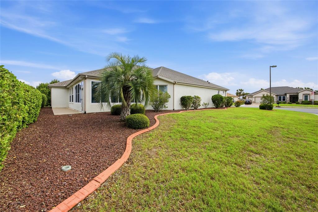 9029 Southeast 130th Loop Summerfield, FL 34491 - Photo 44 of 55 a front view of a house with garden