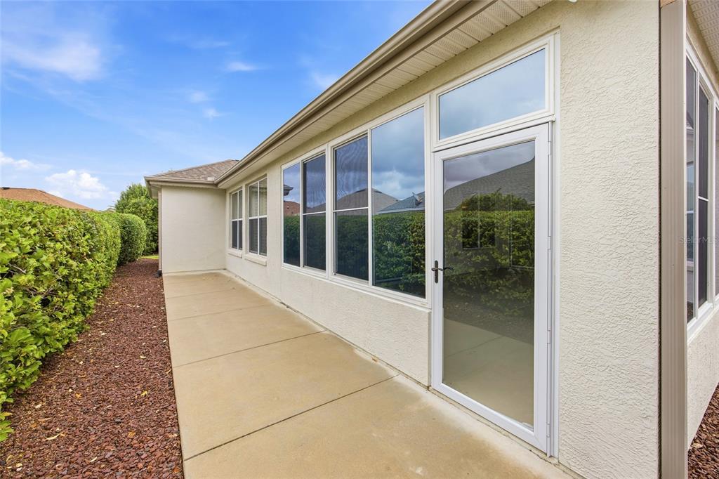 9029 Southeast 130th Loop Summerfield, FL 34491 - Photo 46 of 55 a view of house with backyard and glass windows