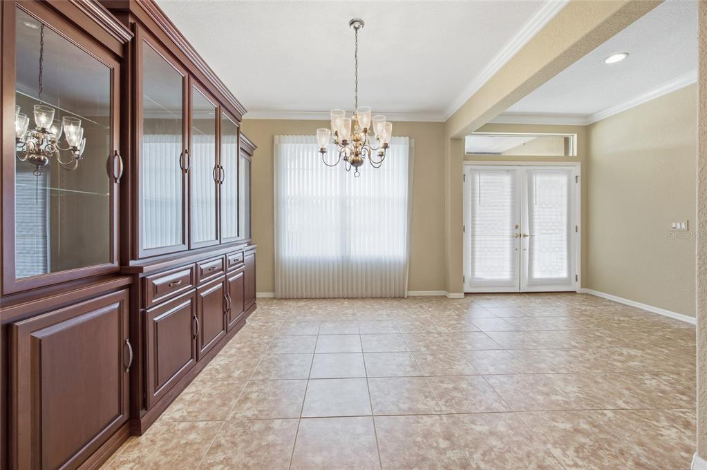 9029 Southeast 130th Loop Summerfield, FL 34491 - Photo 8 of 55 a view of a hallway with chandelier and glass door