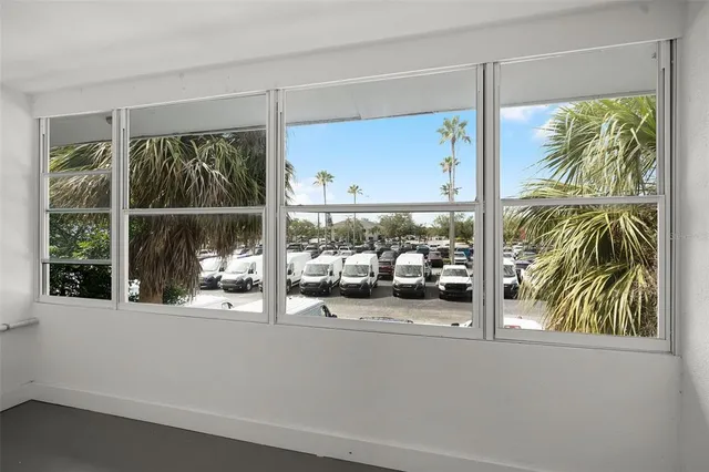 a view of a hallway with wooden floor and a potted plant