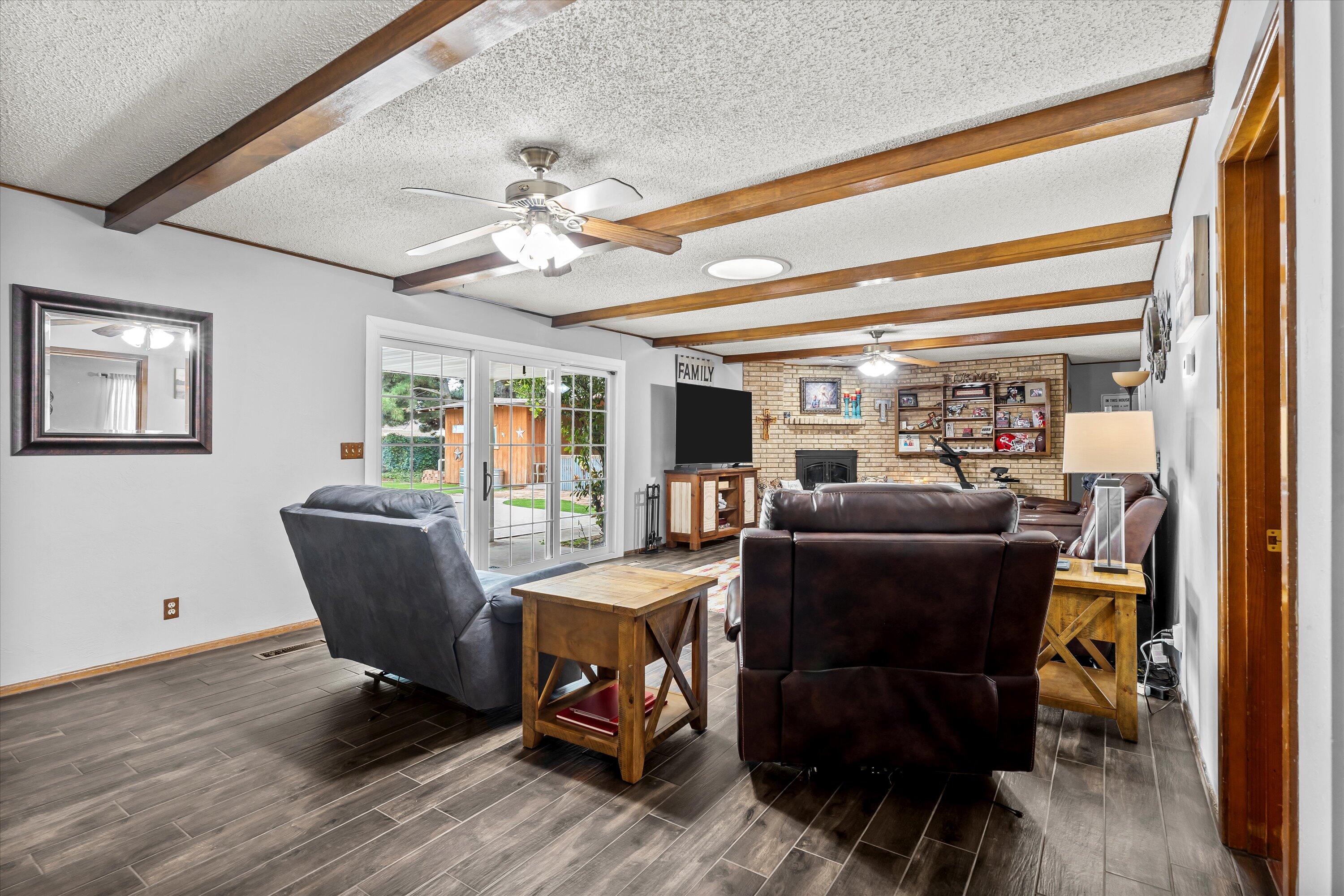 116 East 26th Street Littlefield, TX 79339 - Photo 12 of 40 a dining room with furniture a chandelier and wooden floor