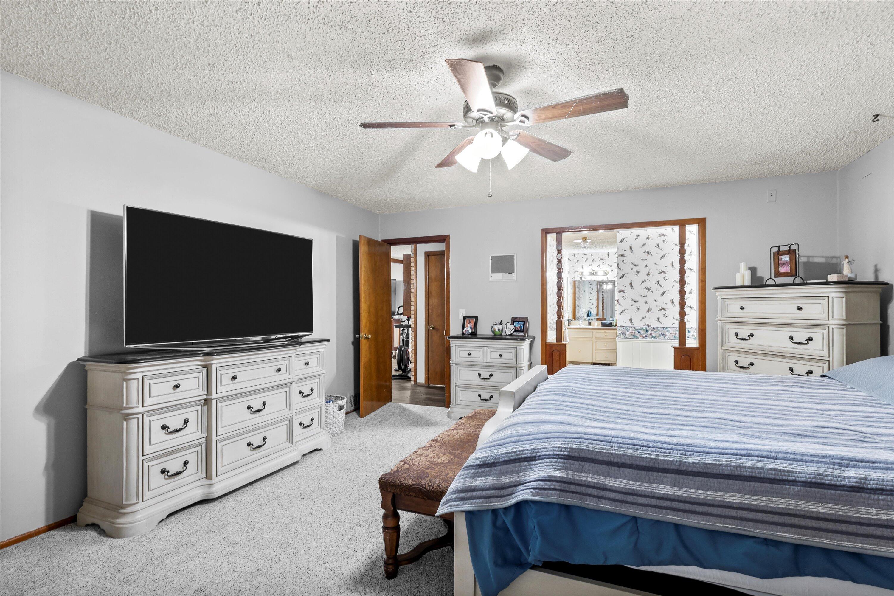 116 East 26th Street Littlefield, TX 79339 - Photo 19 of 40 a bedroom with a bed and a flat screen tv in it