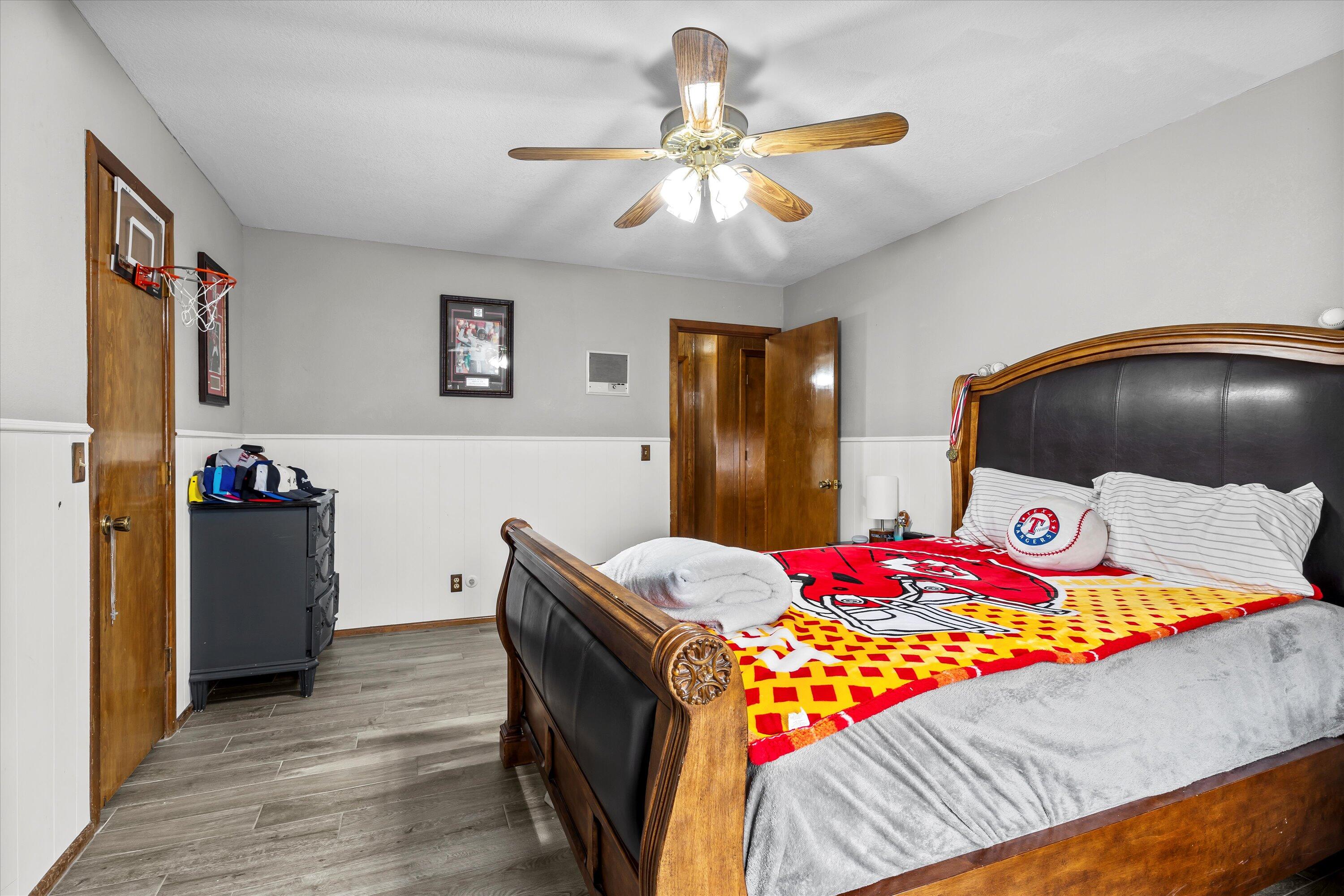 116 East 26th Street Littlefield, TX 79339 - Photo 24 of 40 a bedroom with a bed and a chandelier