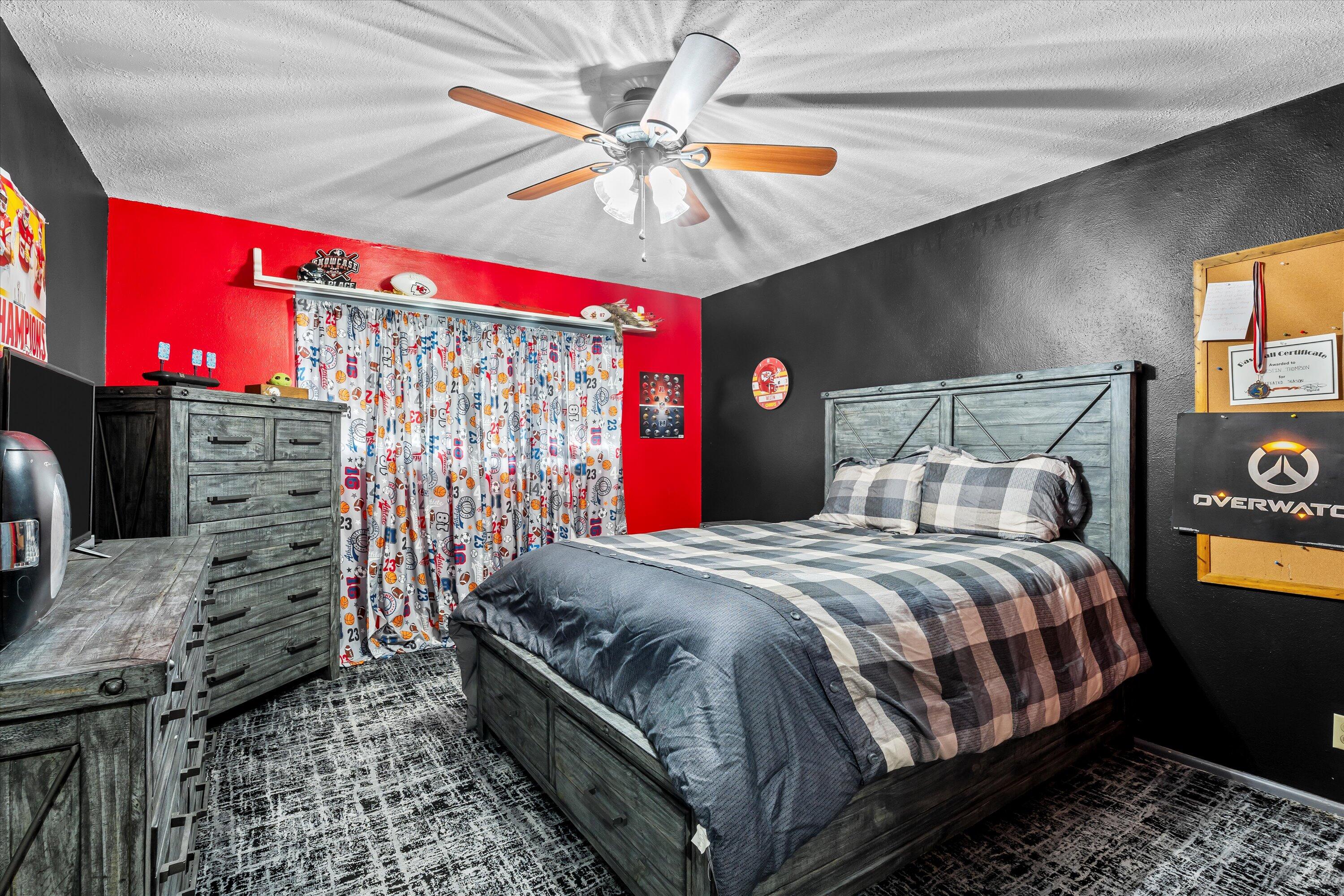 116 East 26th Street Littlefield, TX 79339 - Photo 26 of 40 a bedroom with a bed and a chandelier