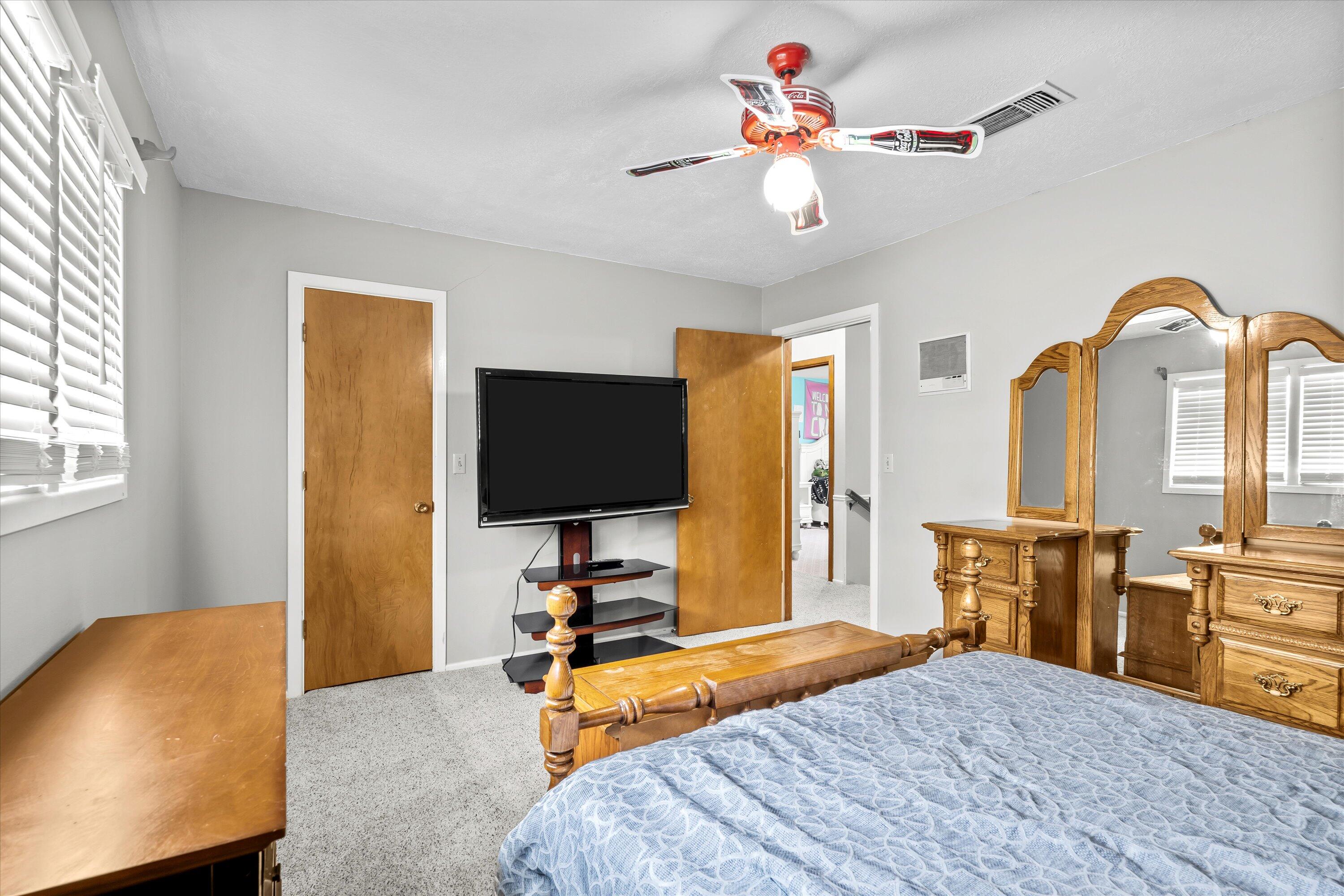116 East 26th Street Littlefield, TX 79339 - Photo 29 of 40 a bedroom with a bed and a flat screen tv with the dresser