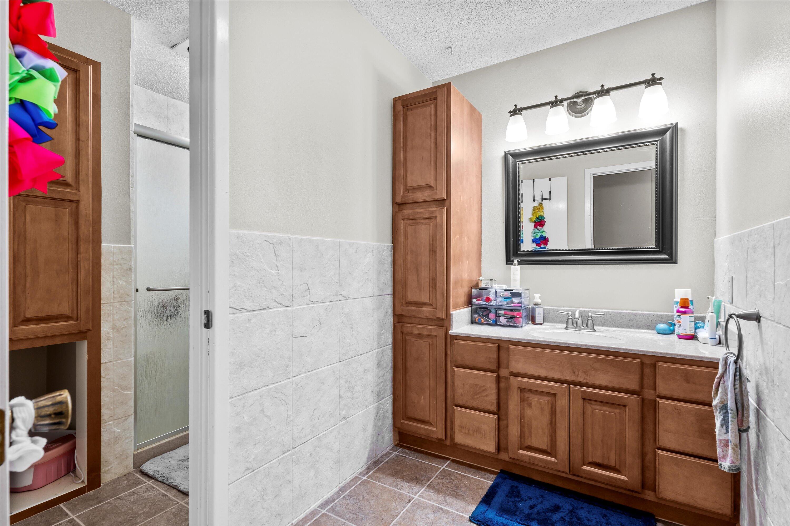 116 East 26th Street Littlefield, TX 79339 - Photo 30 of 40 a bathroom with a sink vanity and a mirror
