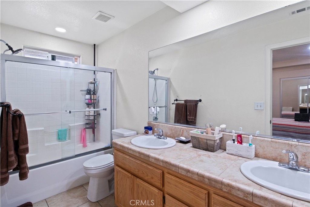14980 Pendleton Street Hesperia, CA 92345 - Photo 14 of 27 a bathroom with a granite countertop sink mirror and toilet