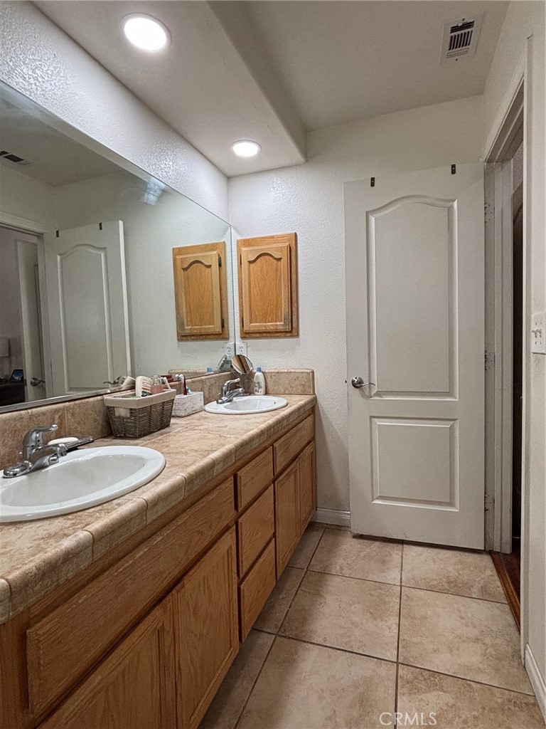 14980 Pendleton Street Hesperia, CA 92345 - Photo 15 of 27 a bathroom with a double vanity sink mirror and
