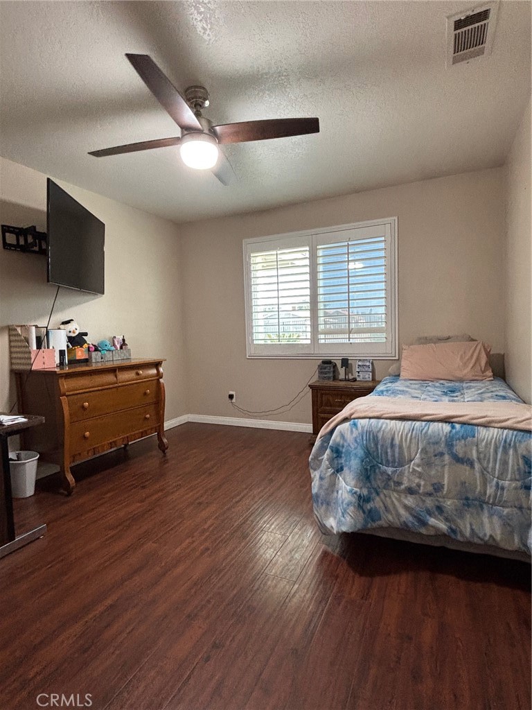 14980 Pendleton Street Hesperia, CA 92345 - Photo 16 of 27 a bedroom with a bed and a flat screen tv