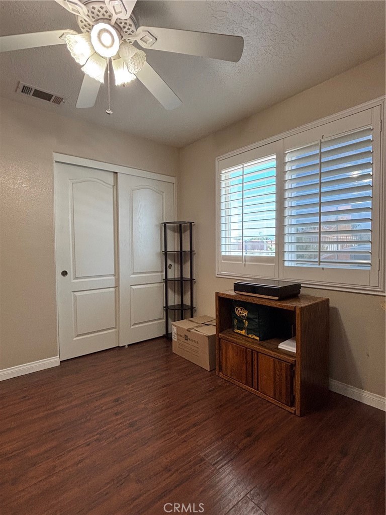 14980 Pendleton Street Hesperia, CA 92345 - Photo 17 of 27 a kitchen with granite countertop a stove cabinets and wooden floor