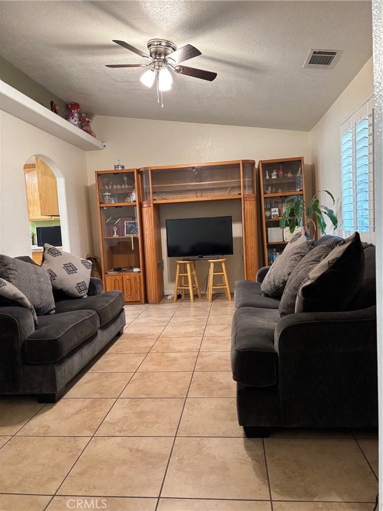 14980 Pendleton Street Hesperia, CA 92345 - Photo 5 of 27 a living room with furniture and a fireplace