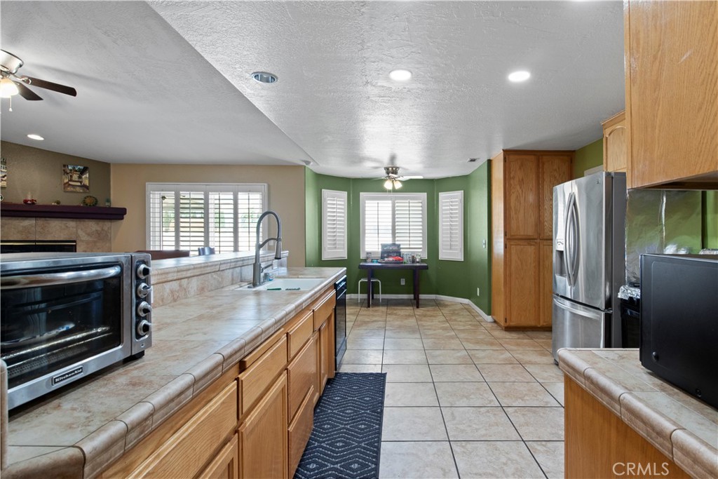 14980 Pendleton Street Hesperia, CA 92345 - Photo 7 of 27 a large kitchen with a large counter top appliances and cabinets