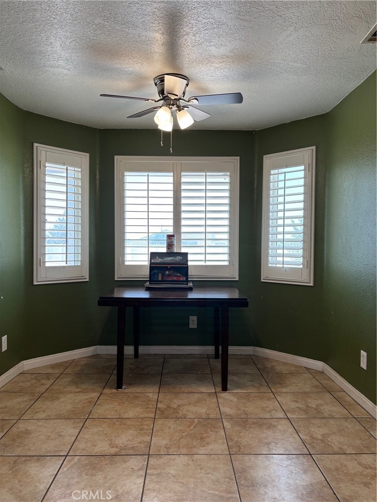 14980 Pendleton Street Hesperia, CA 92345 - Photo 8 of 27 a view of a workspace with furniture and a window