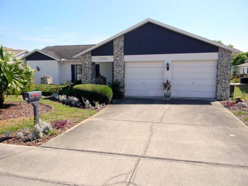 7624 Limington Drive Port Richey, FL 34668 - Photo 1 of 1 Exterior Front - Well maintained yard and home.
