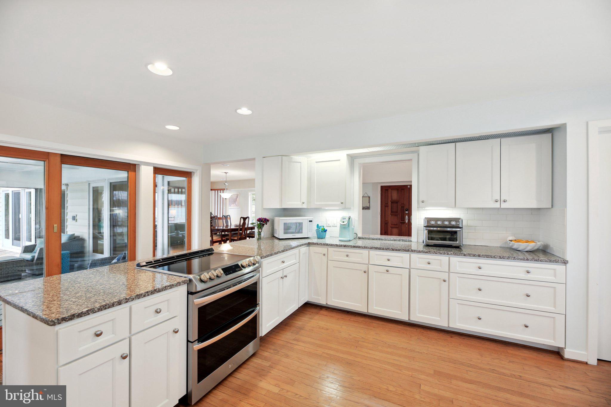 1601 Cliff Drive Edgewater, MD 21037 - Photo 17 of 86 a large kitchen with granite countertop a large window and white stainless steel appliances