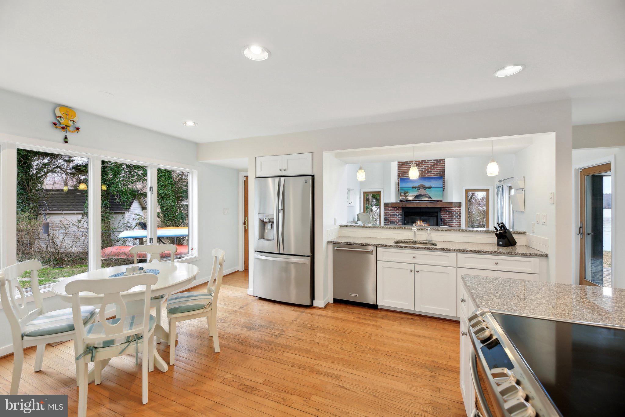 1601 Cliff Drive Edgewater, MD 21037 - Photo 22 of 86 a kitchen with stainless steel appliances kitchen island granite countertop a refrigerator and a stove top oven