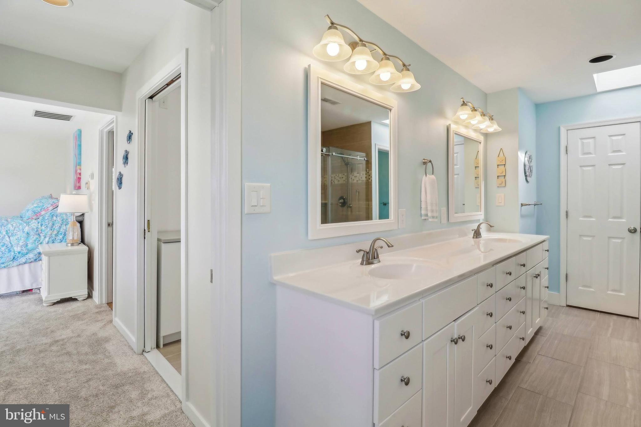 1601 Cliff Drive Edgewater, MD 21037 - Photo 48 of 86 a bathroom with a double vanity sink and mirror with shower