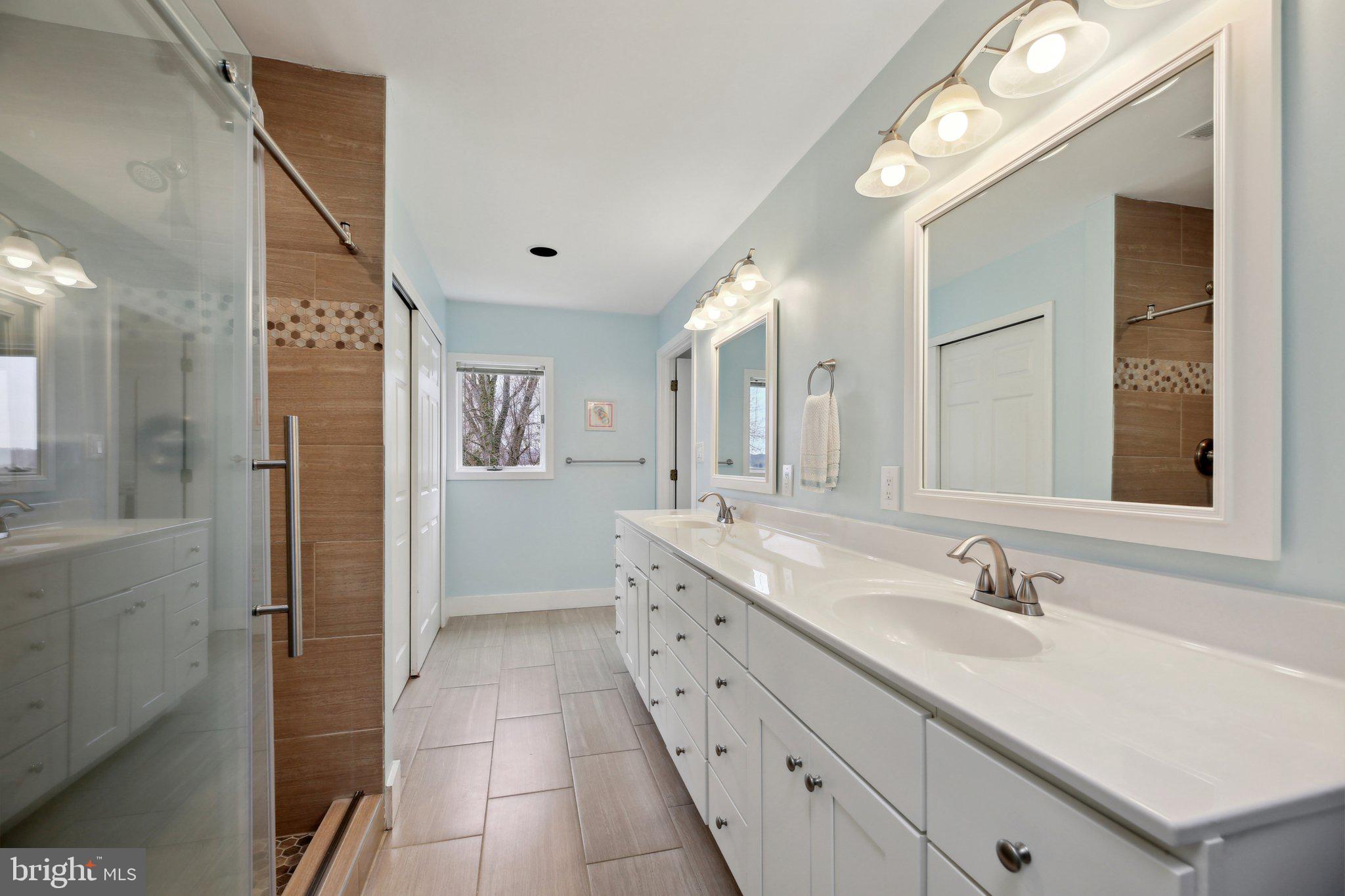 1601 Cliff Drive Edgewater, MD 21037 - Photo 50 of 86 a spacious bathroom with a granite countertop sink a mirror and a shower