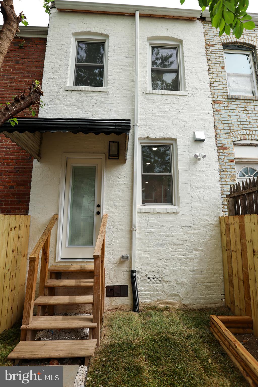 2039 Rosedale Street Northeast Washington, DC 20002 - Photo 17 of 18 a view of a house with a door and a yard
