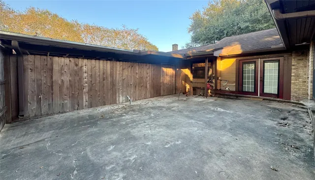 a backyard of a house with barbeque oven table and chairs