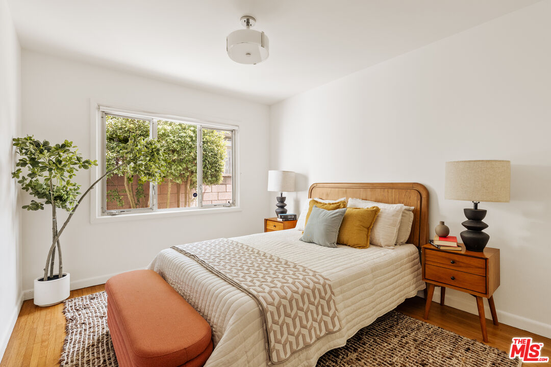 10749 Molony Road Culver City, CA 90230 - Photo 17 of 19 a bedroom with bed and a potted plant