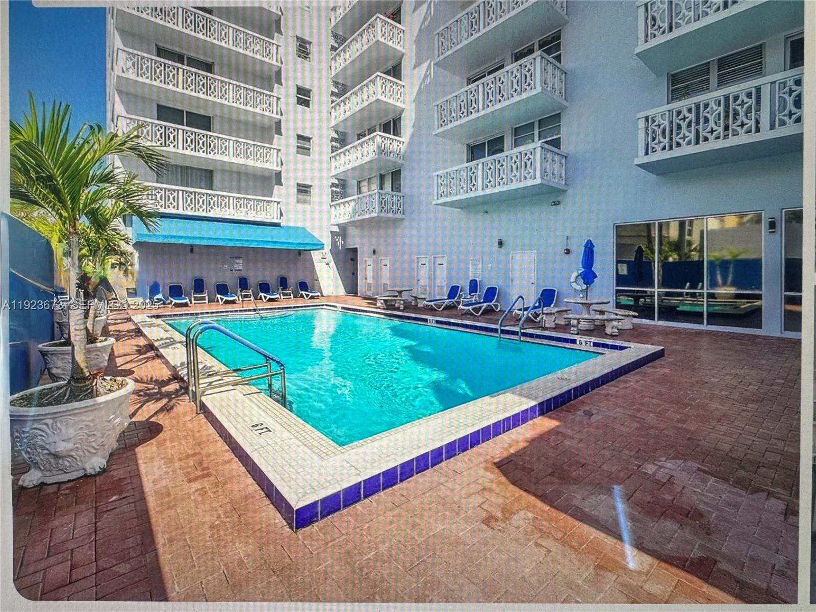 1020 Meridian Avenue, Unit 608 Miami Beach, FL 33139 - Photo 2 of 5 a view of a building with a swimming pool