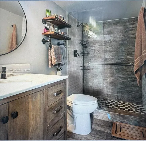 a bathroom with a sink toilet and shower