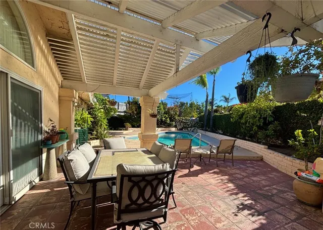 a view of a patio with table and chairs and potted plants