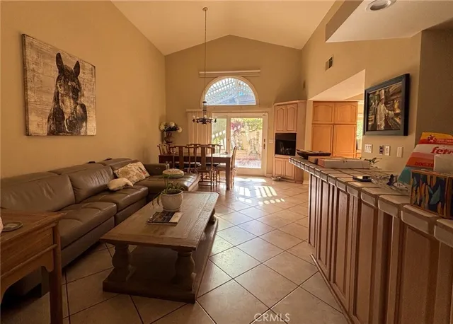a living room with furniture a fireplace and a chandelier