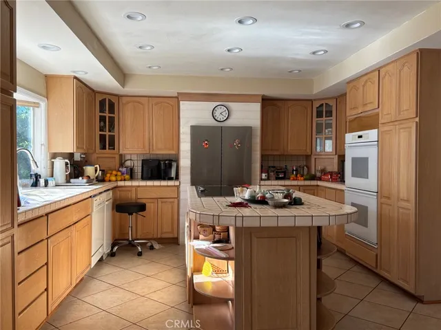 a kitchen with stainless steel appliances a sink stove and refrigerator
