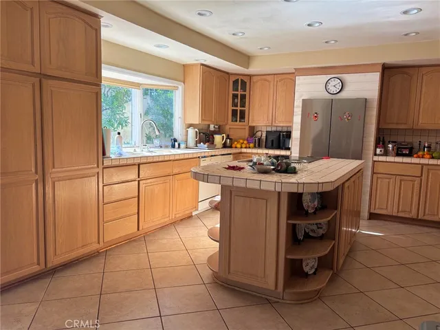 a kitchen with stainless steel appliances a stove a sink and a refrigerator