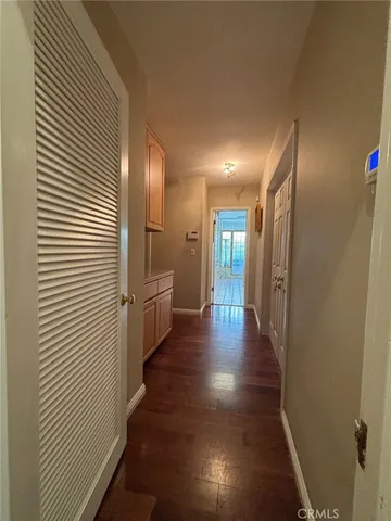 a view of a hallway with the wooden shelves