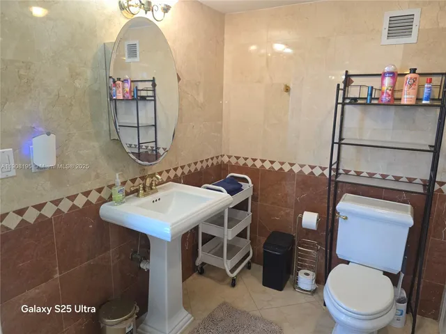 a bathroom with a sink a toilet and a shower