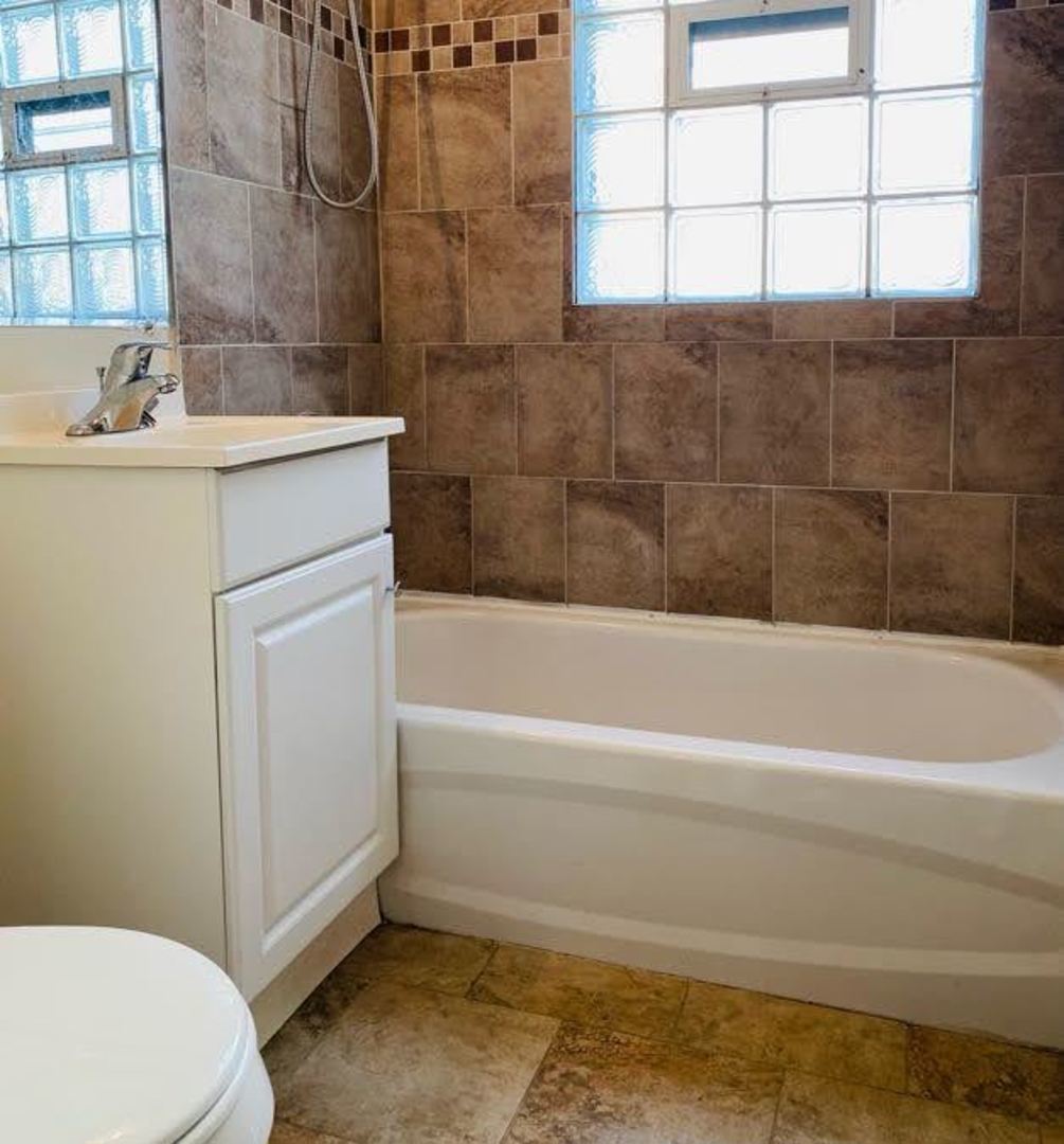 17543 Roy Street Lansing, IL 60438 - Photo 12 of 13 a bathroom with a sink a toilet and shower