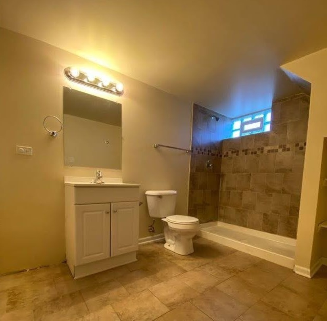 17543 Roy Street Lansing, IL 60438 - Photo 13 of 13 a bathroom with a toilet sink and shower