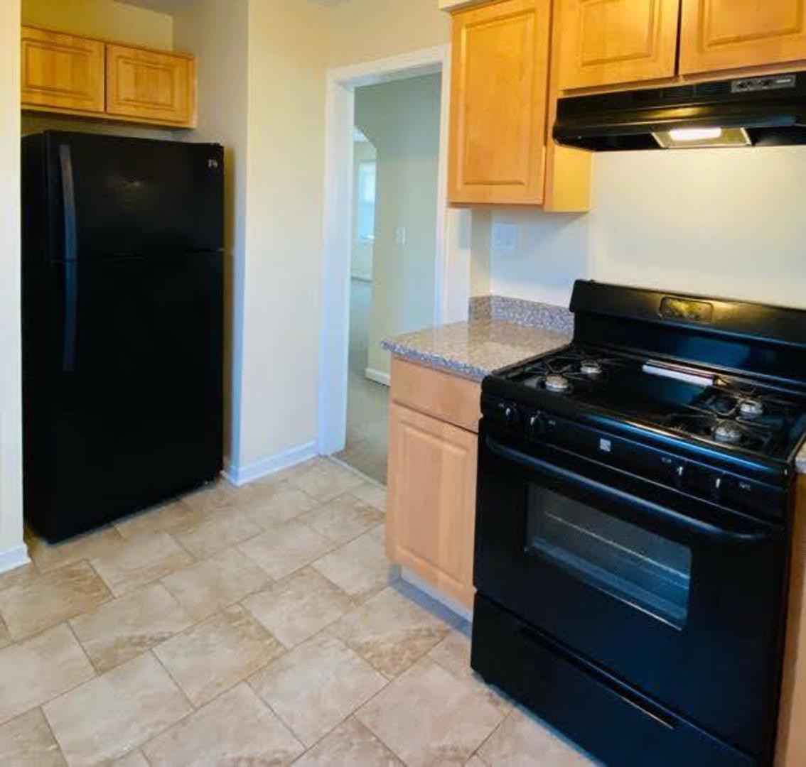17543 Roy Street Lansing, IL 60438 - Photo 6 of 13 a kitchen with a stove and a cabinets