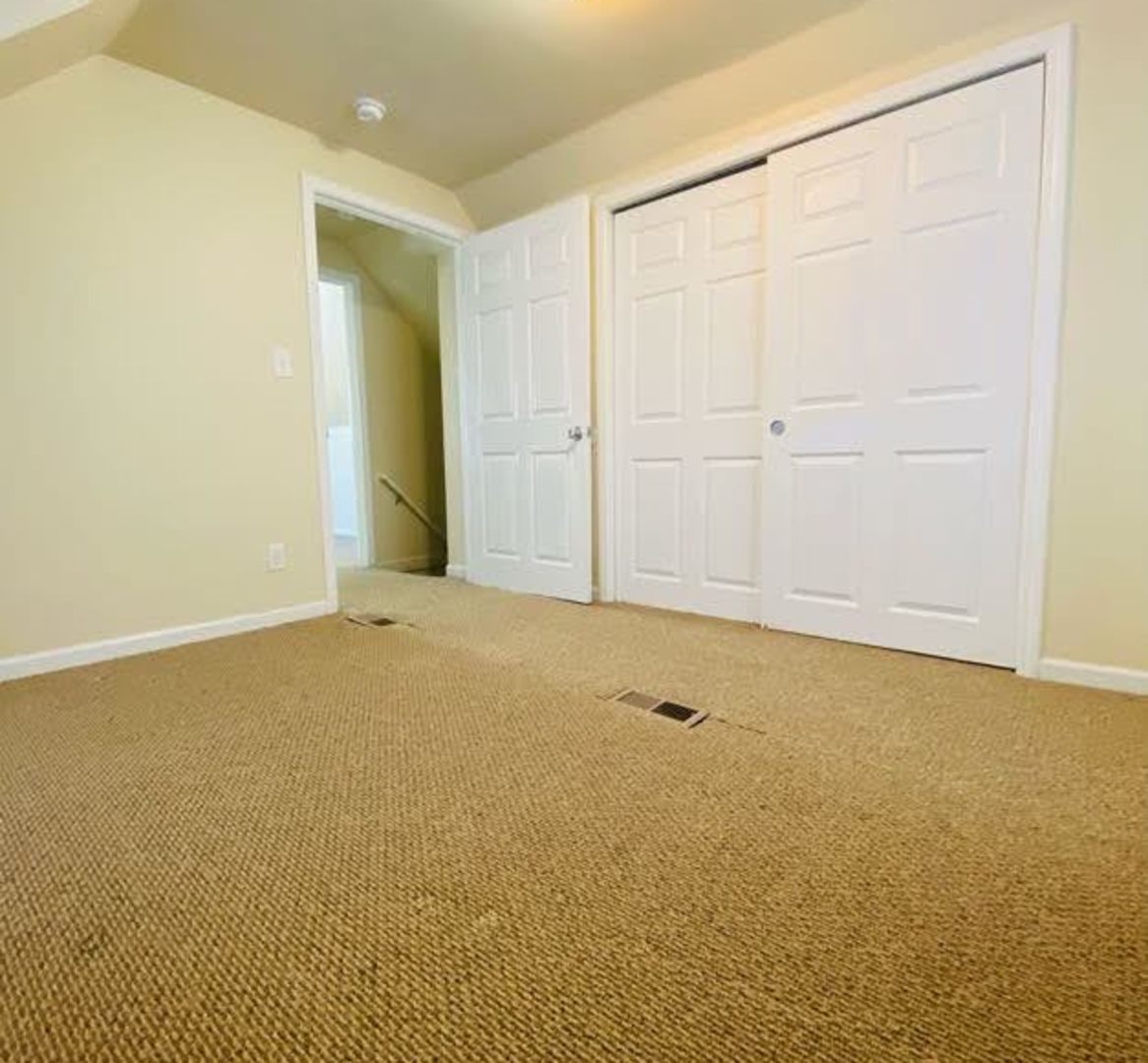 17543 Roy Street Lansing, IL 60438 - Photo 8 of 13 an empty room with an entryway