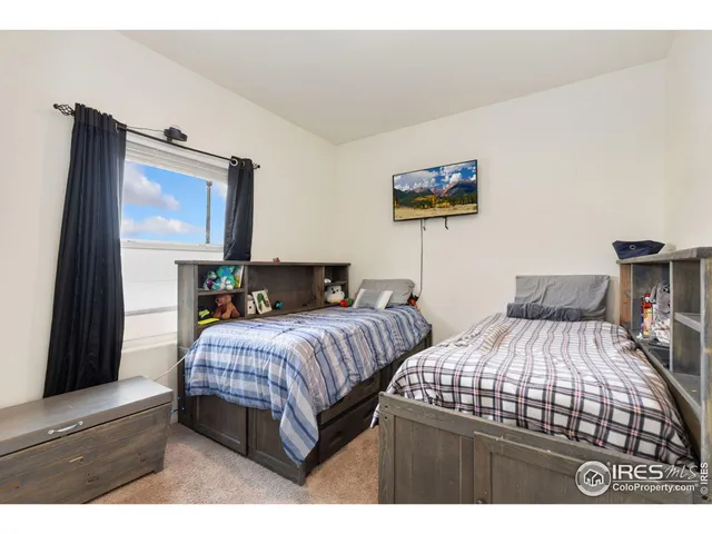 a bedroom with a bed and a black tv