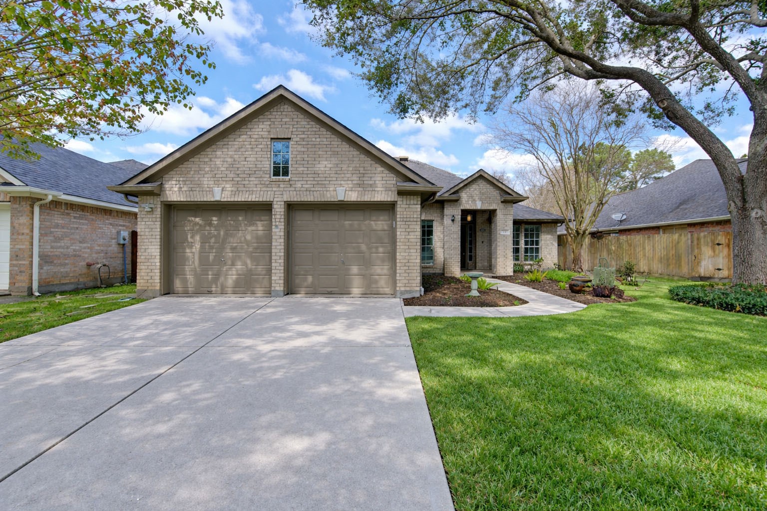 a front view of a house with yard and green space