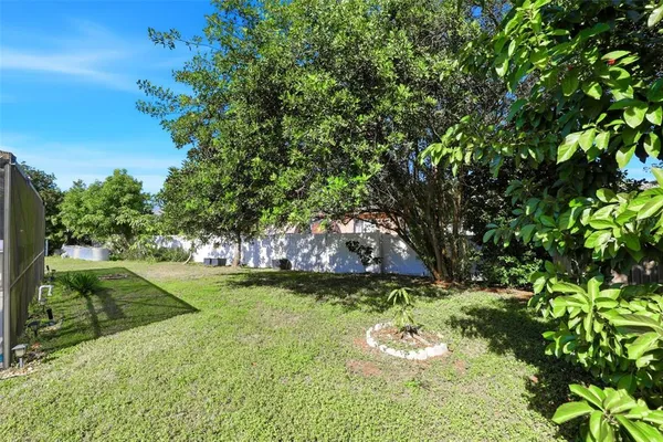 a swimming pool with outdoor seating and plants