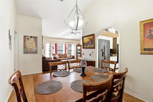 a dining room with furniture a rug and wooden floor