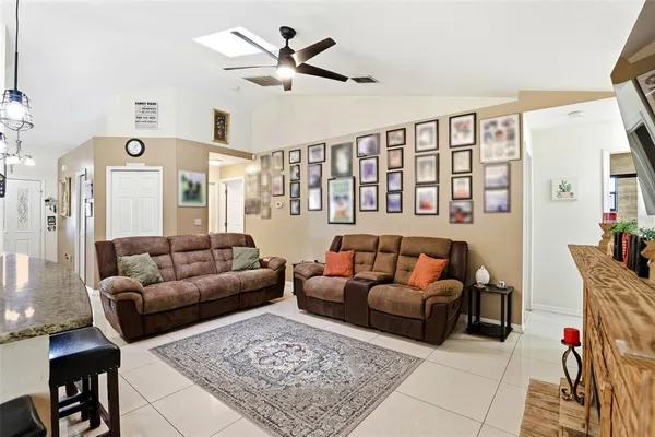 a living room with furniture ceiling fan and a rug