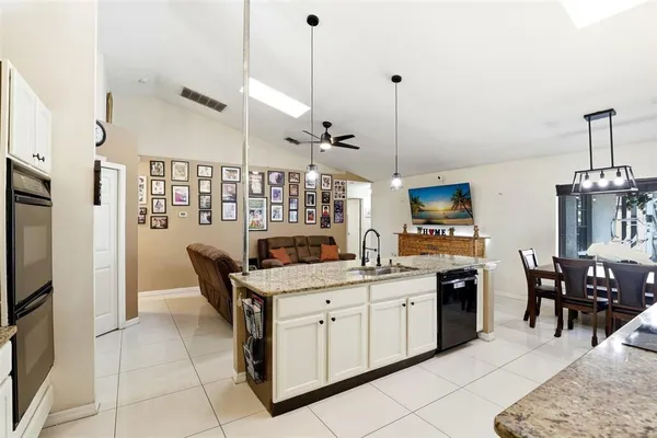a kitchen with cabinets and chairs