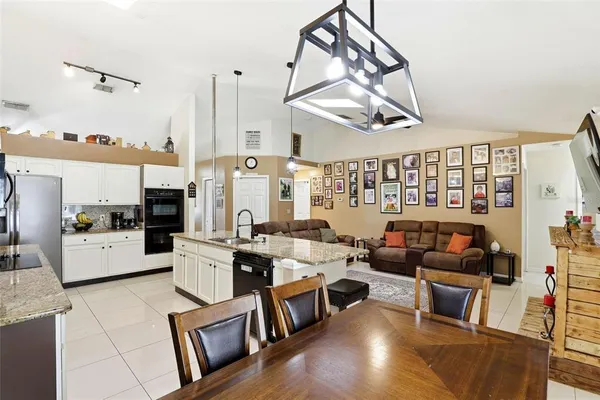 a living room with furniture a rug and a chandelier